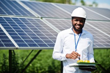 Worker near solar panels